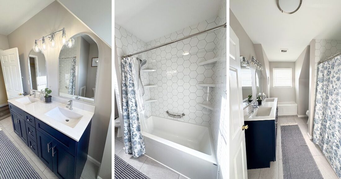 navy blue vanity with arch mirrors. silver hardware and bathroom lighting