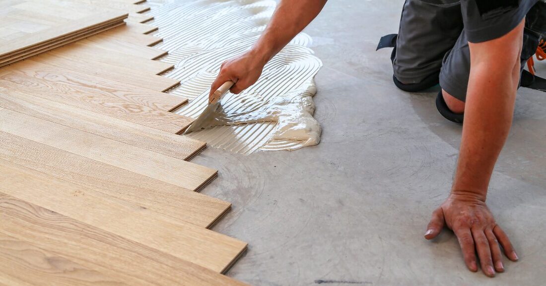 light wood colored LVP flooring being installed in a chevron pattern
