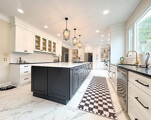 Custom white shaker kitchen cabinets with glass-front upper cabinets, black countertops, white subway tile backsplash, and matte black hardware in a bright modern kitchen remodel.
