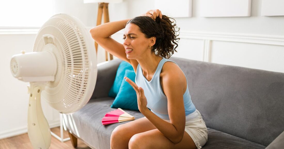 a woman who can't cool off sitting in front of a fan in south jersey